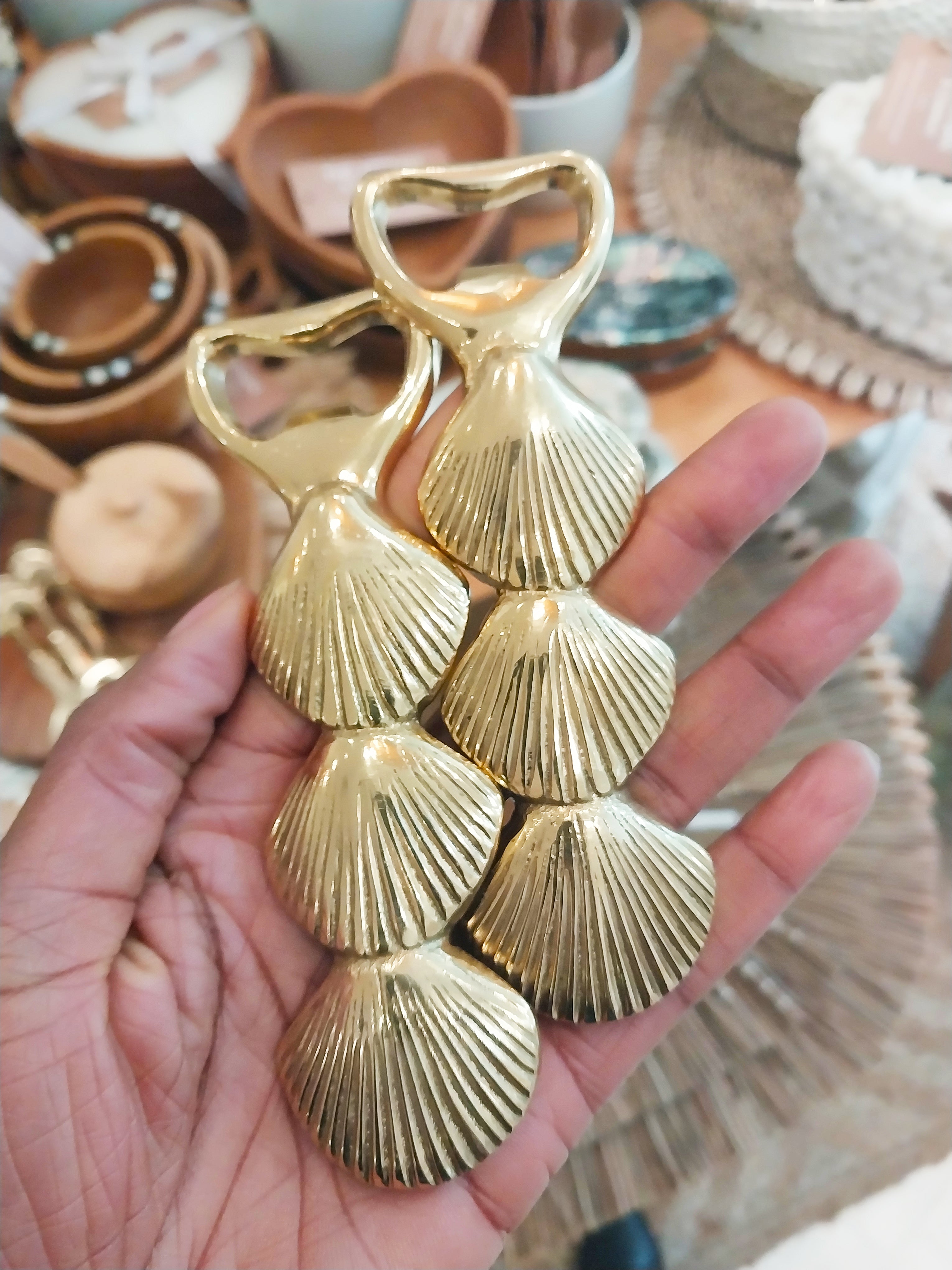 Hand holder two brass sea shell bottle opener
