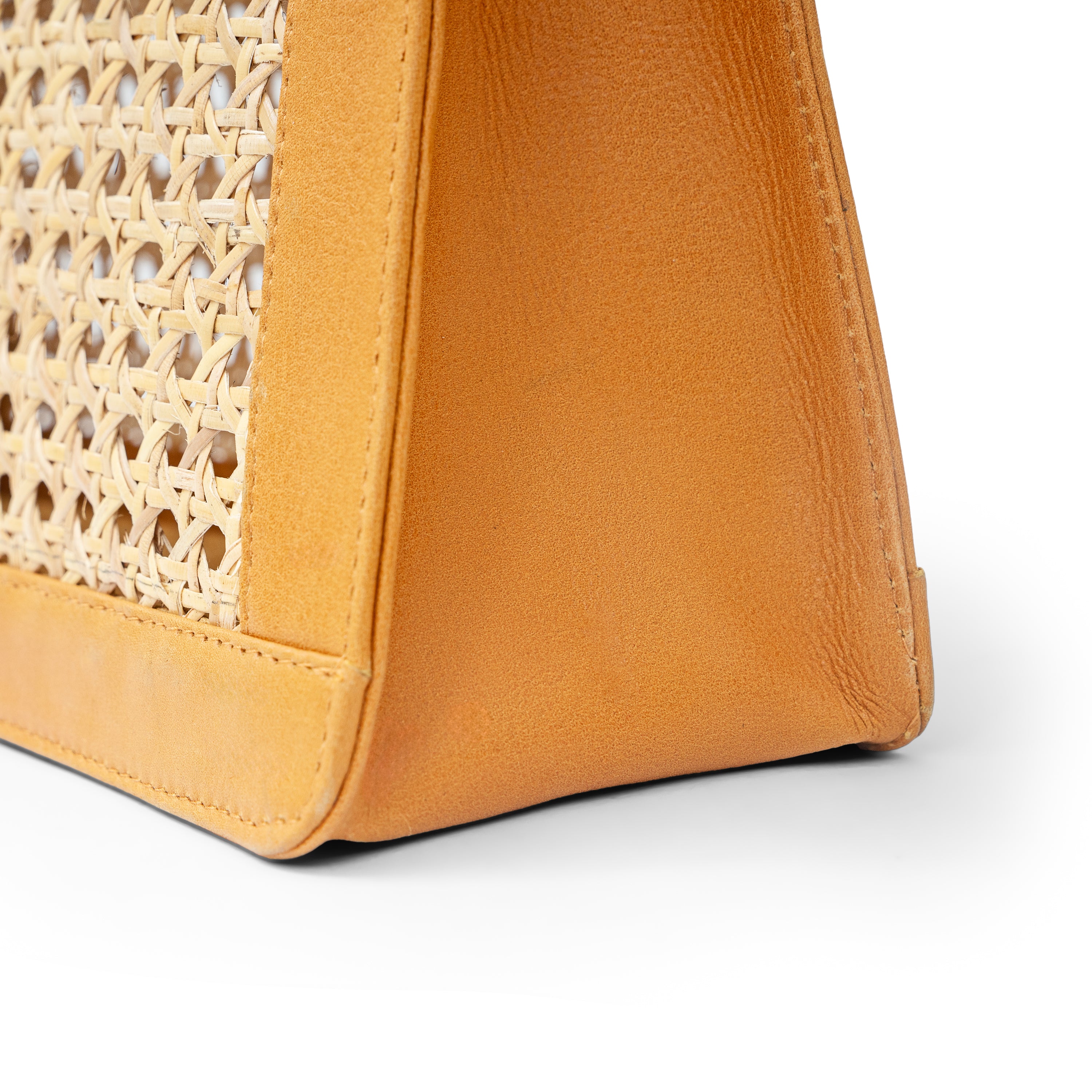 Detail view tan leather and cane webbing rattan top handle tote handbag