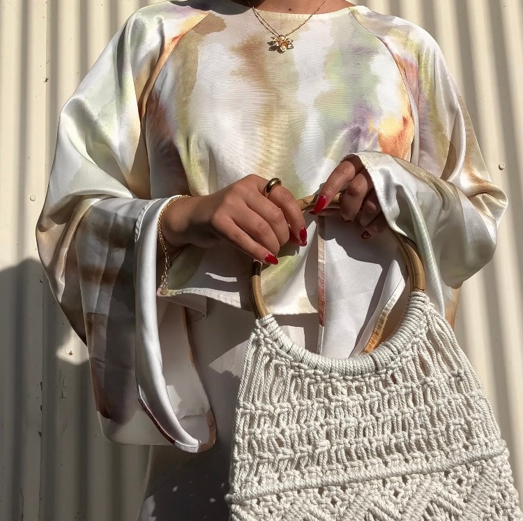 Model holding Beige Macrame Bag With Top Handle