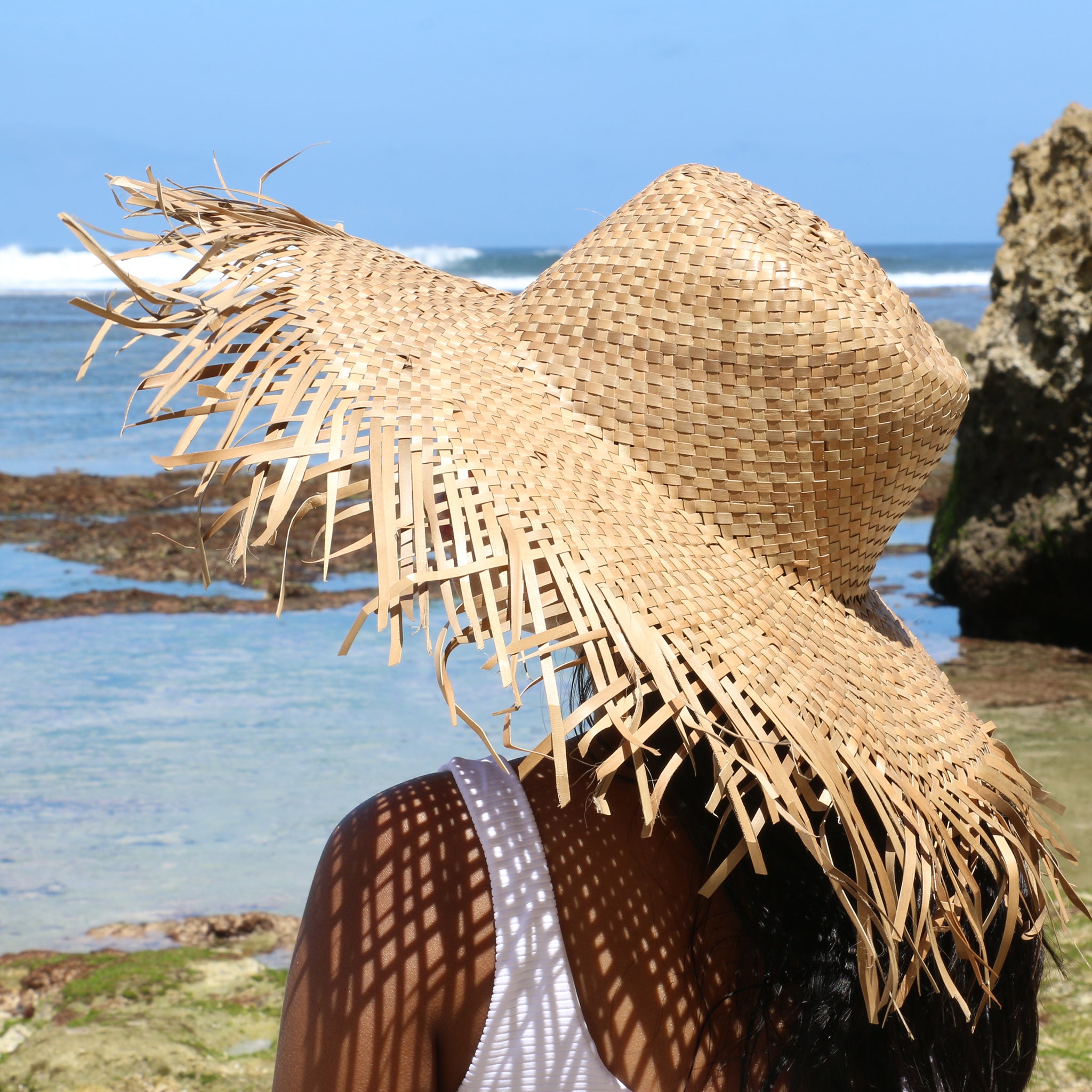 Model on the beach wearing Wide Brim Raffia Straw Hat