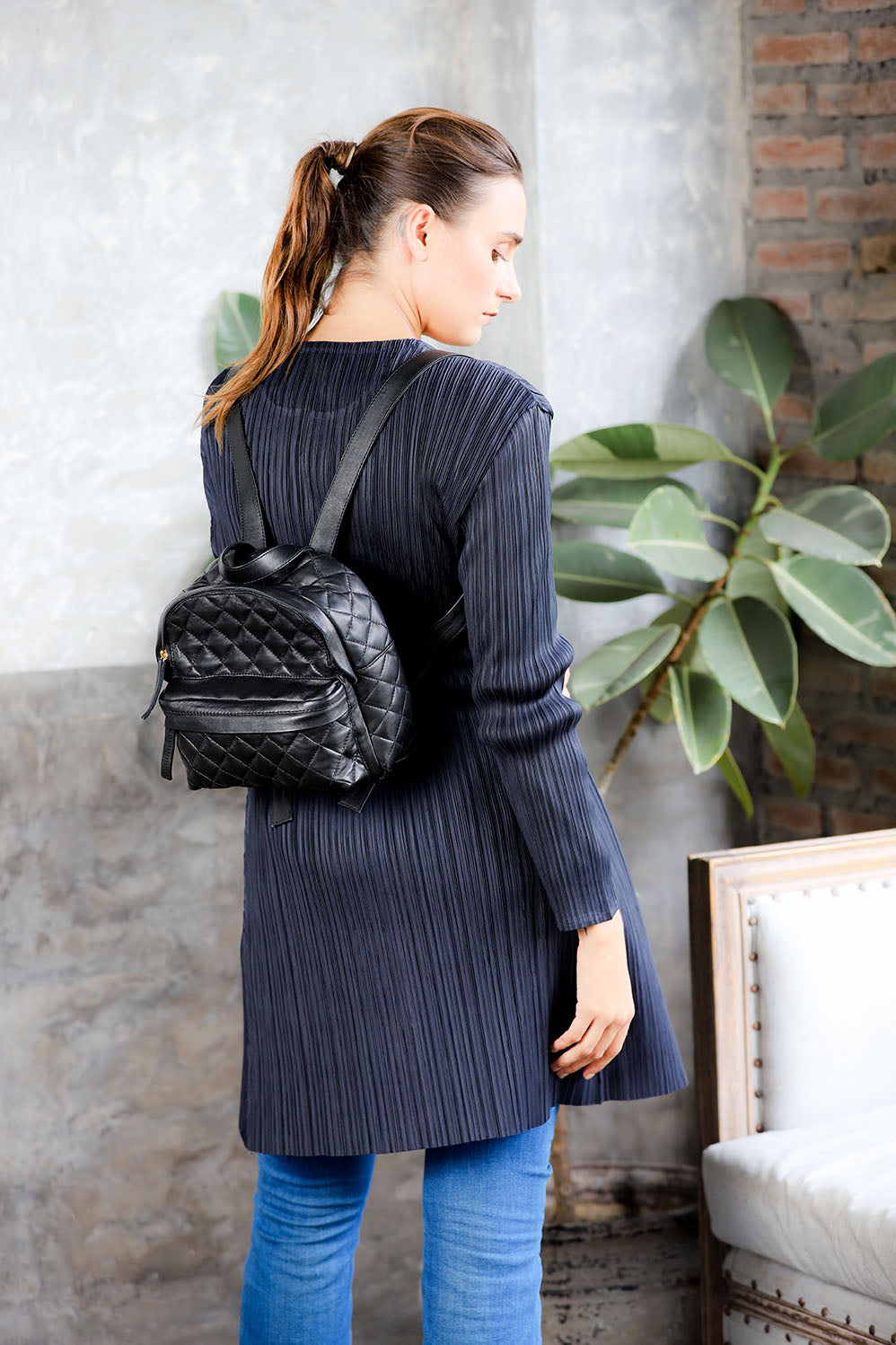 model waring black quilted leather small women backpack