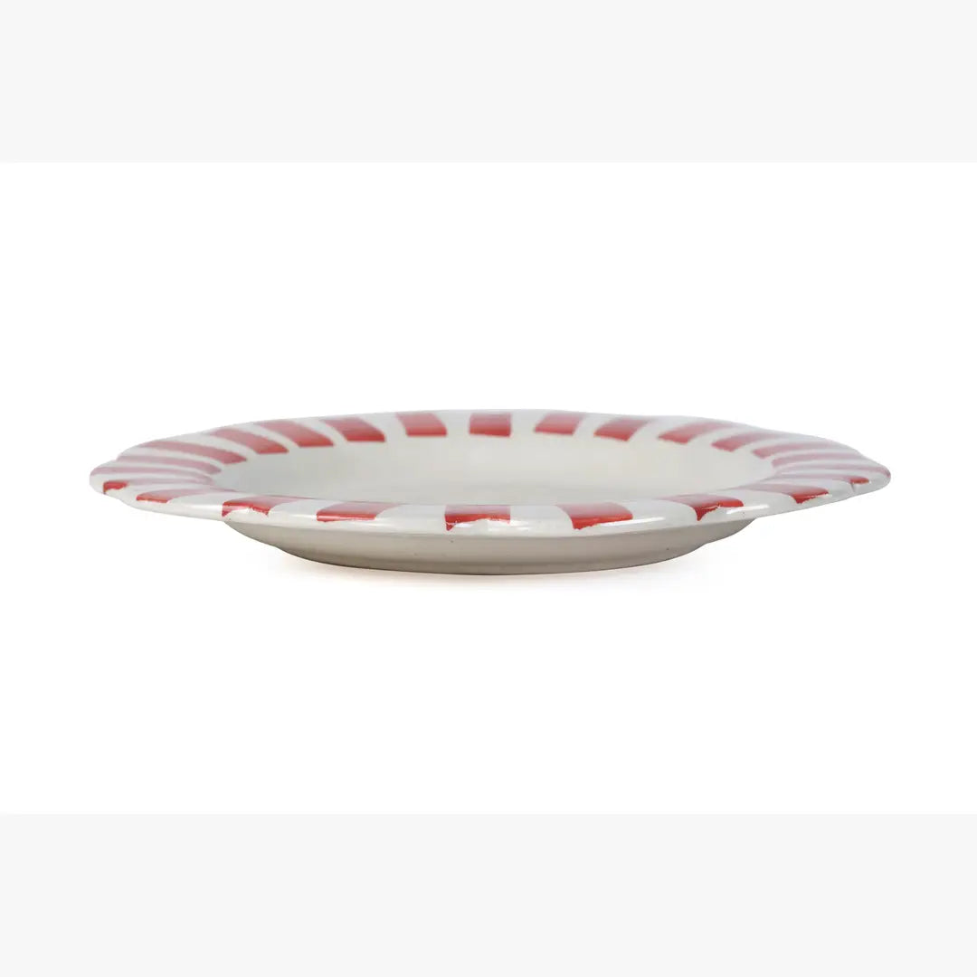 White plate with red stripes on a white background