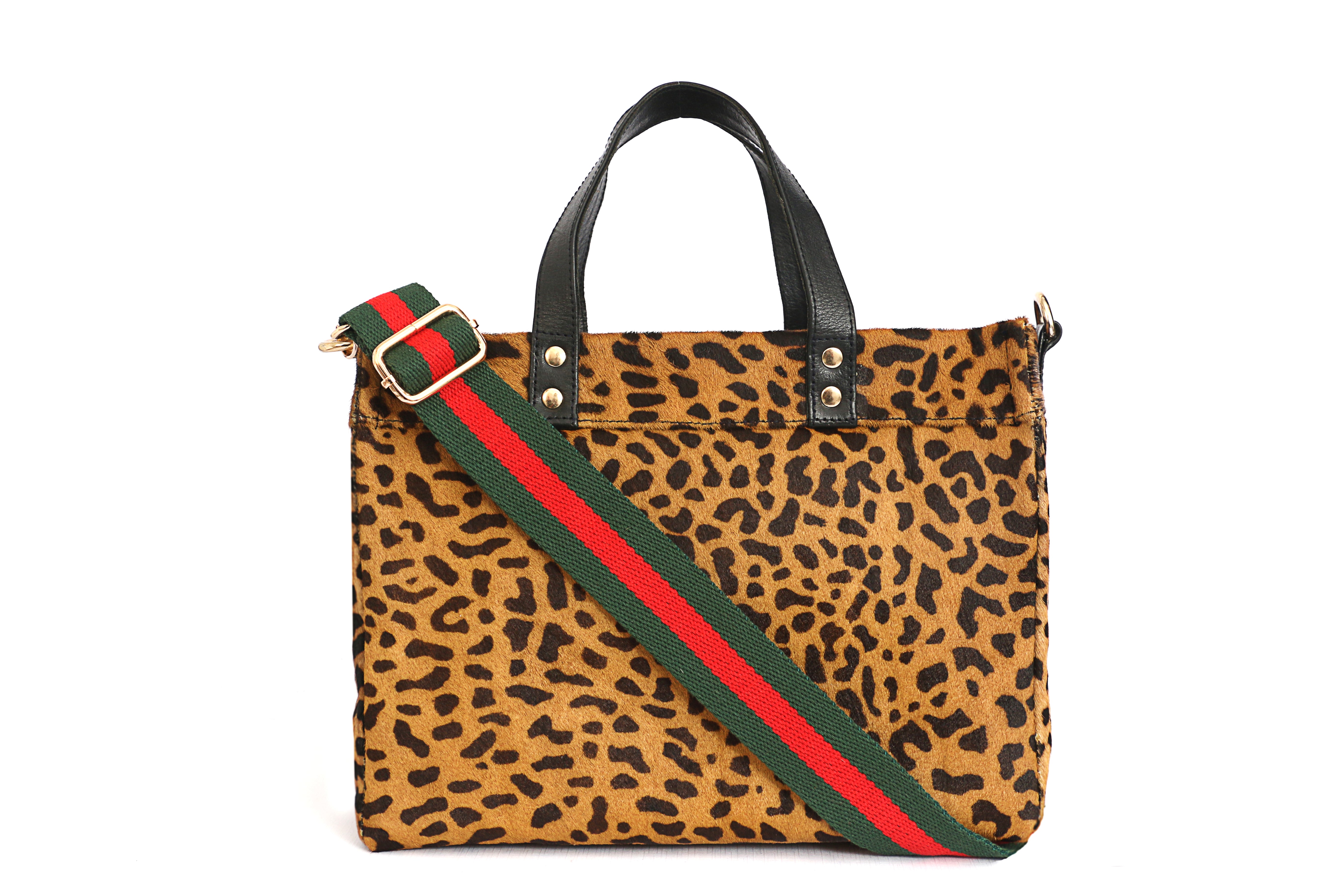 Leopard print handbag with a green and red strap on a white background