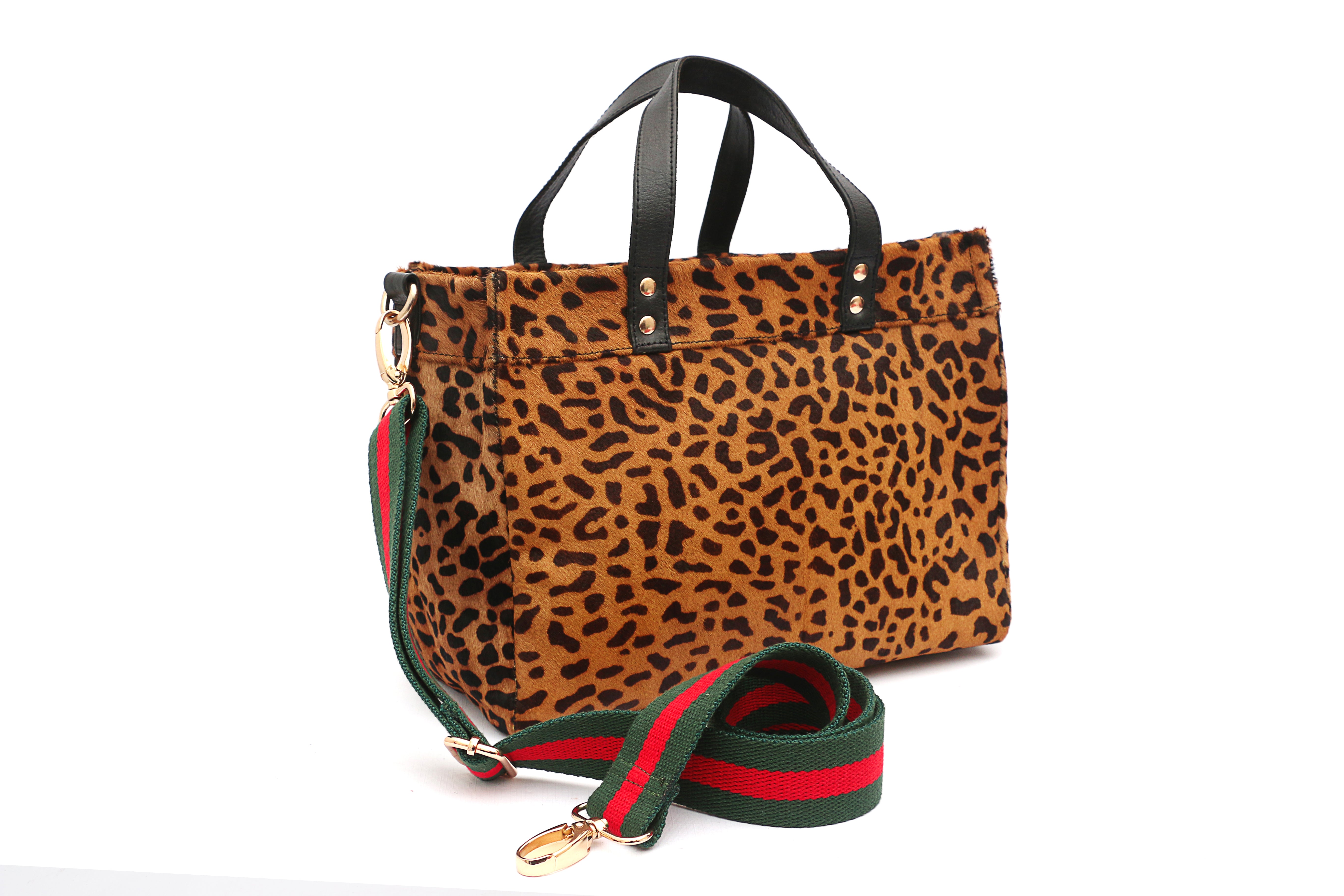 Side view of Leopard print handbag with green and red strap on a white background