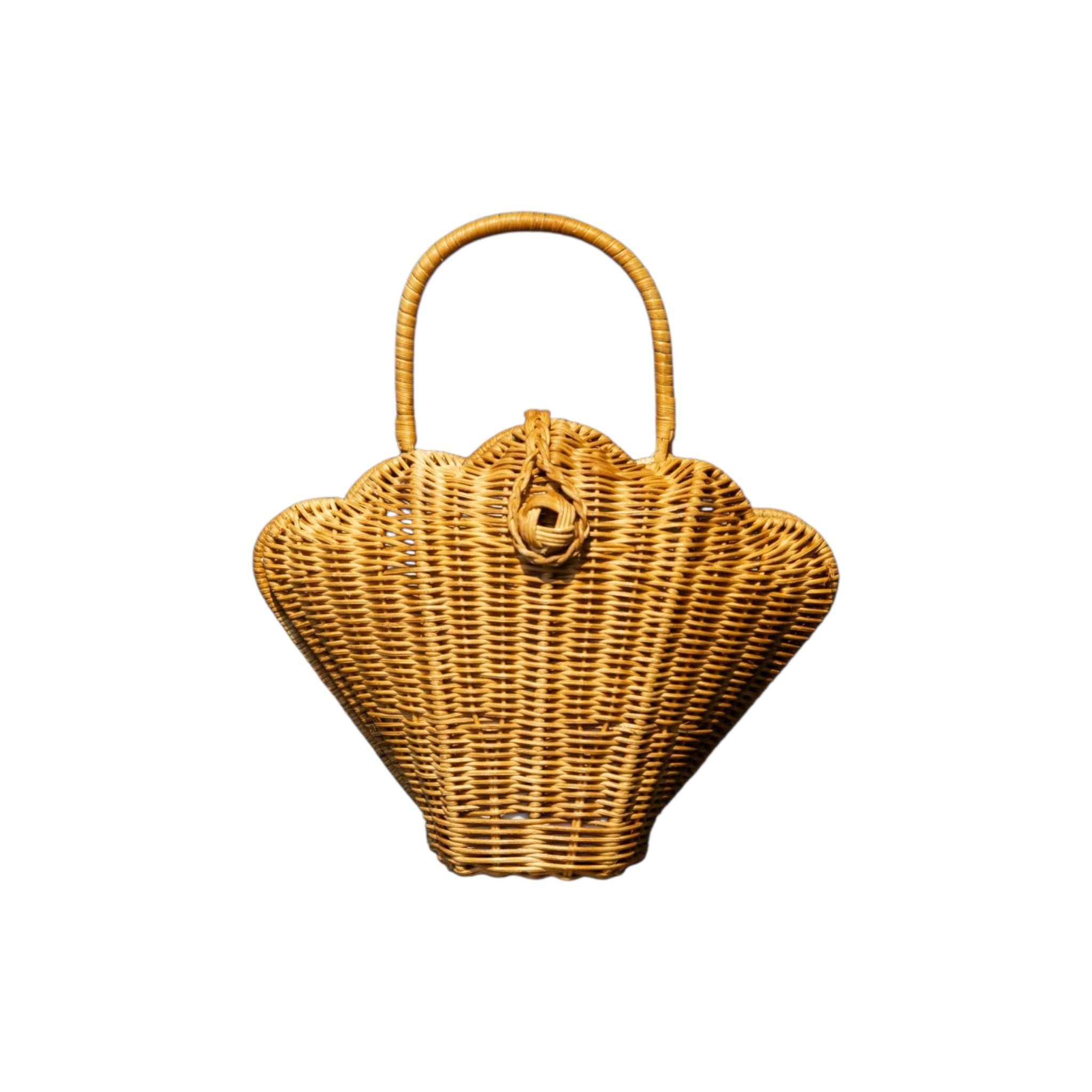 A natural handwoven rattan handbag shaped like a scalloped basket, featuring a single top handle and a decorative woven clasp at the top center with a fully lined interior.