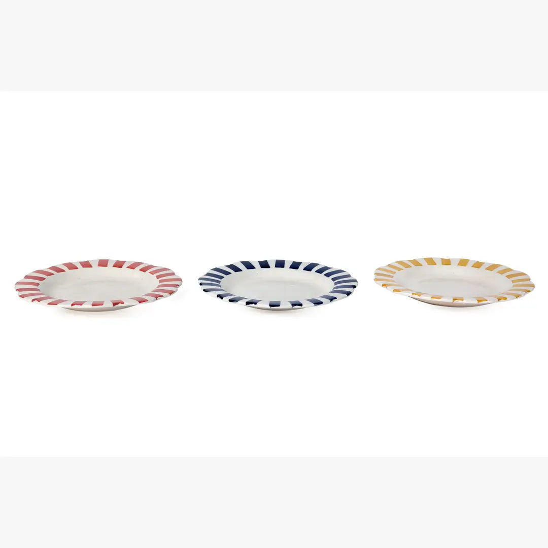 Three small ceramic plates with colorful striped rims on a white background