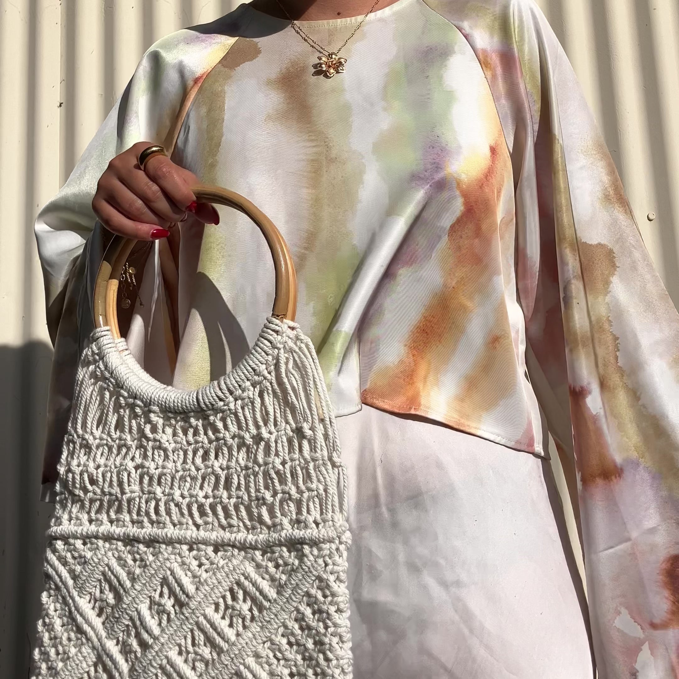 Video of model wearing beige macrame crochet bag with handles