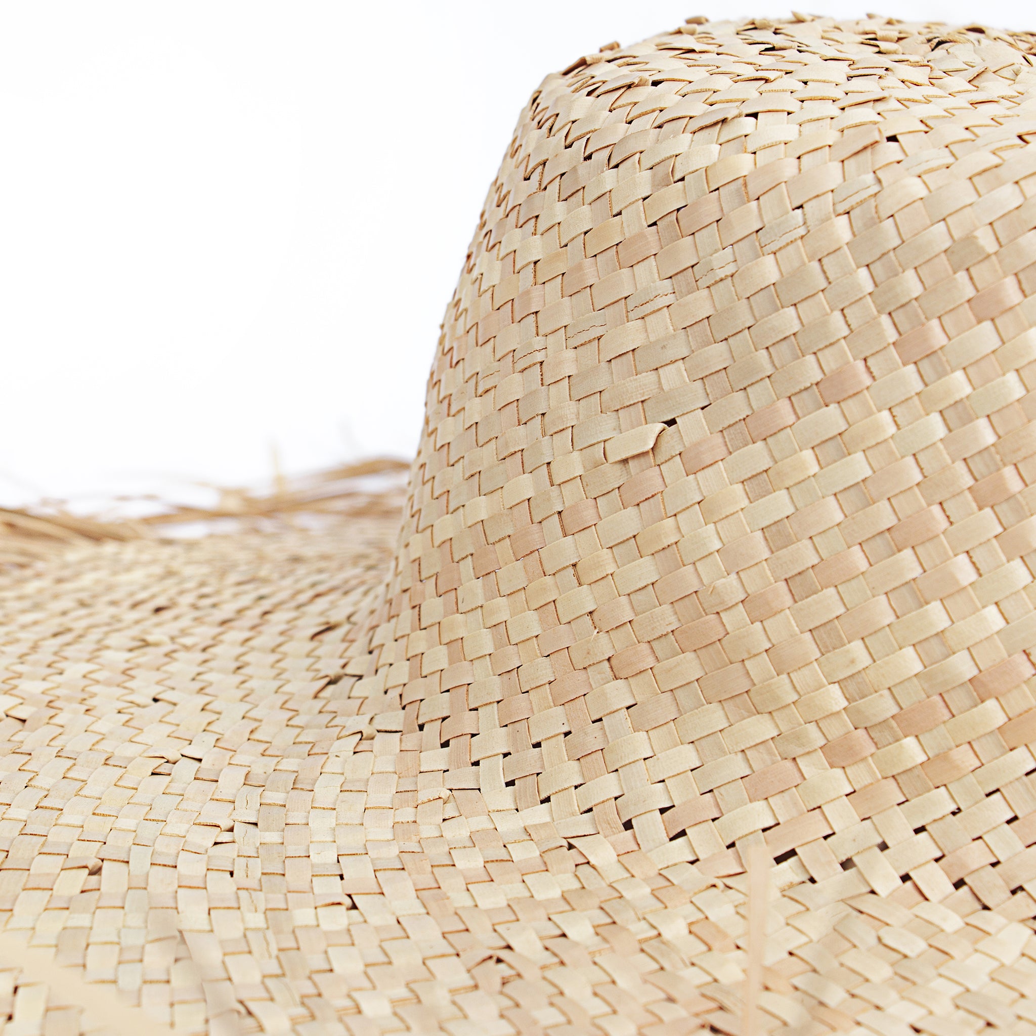 Close up view natural wide brim with frayed edge women straw raffia sun hat