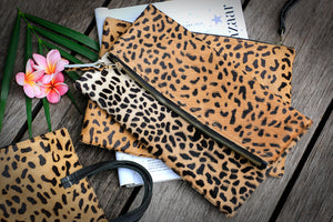 Lifestyle view of leopard leather foldover women clutch bag