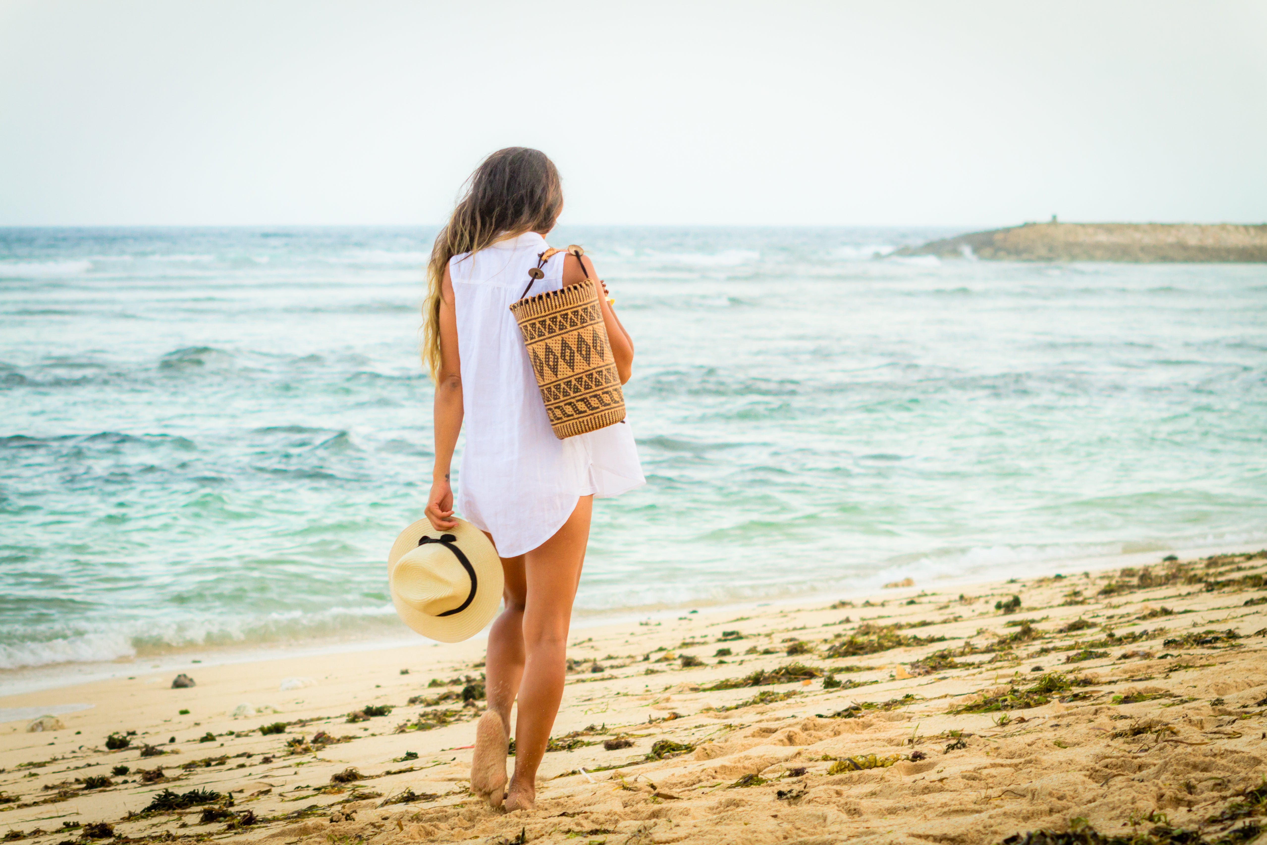 Model on beach wearing Made in Bali Woven Basket Women Backpack