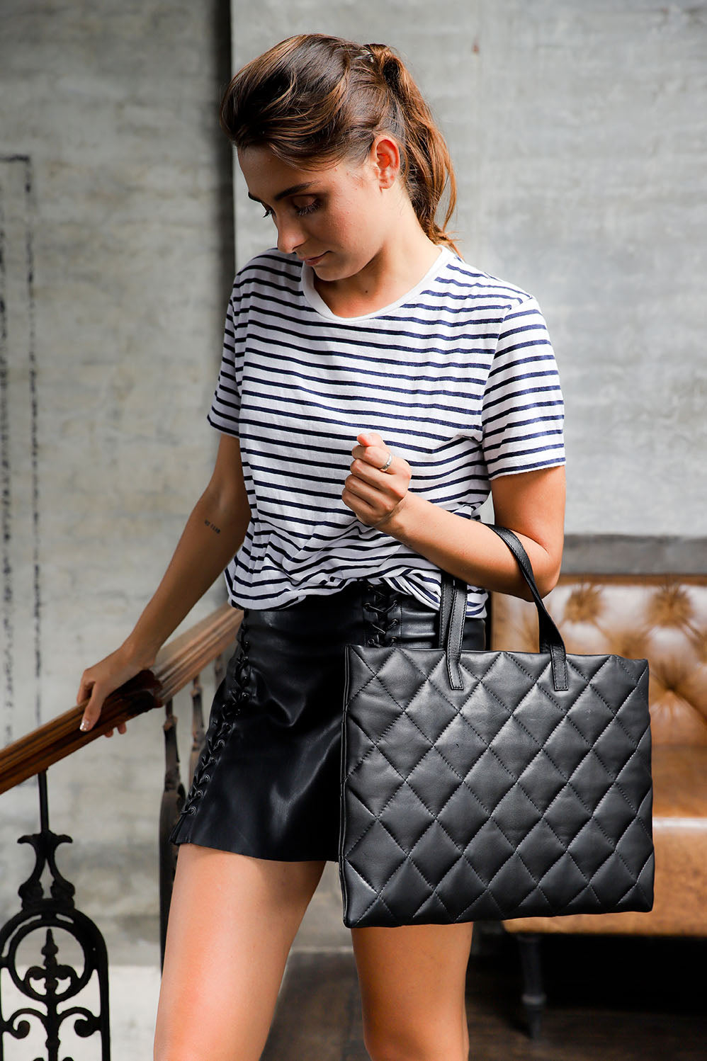 Quilted black leather tote model wearing