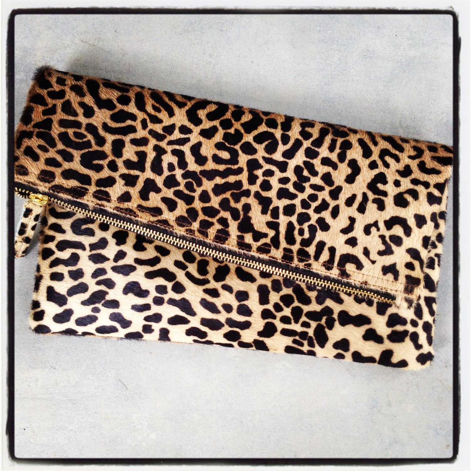 Styled view of leopard clutch handbag