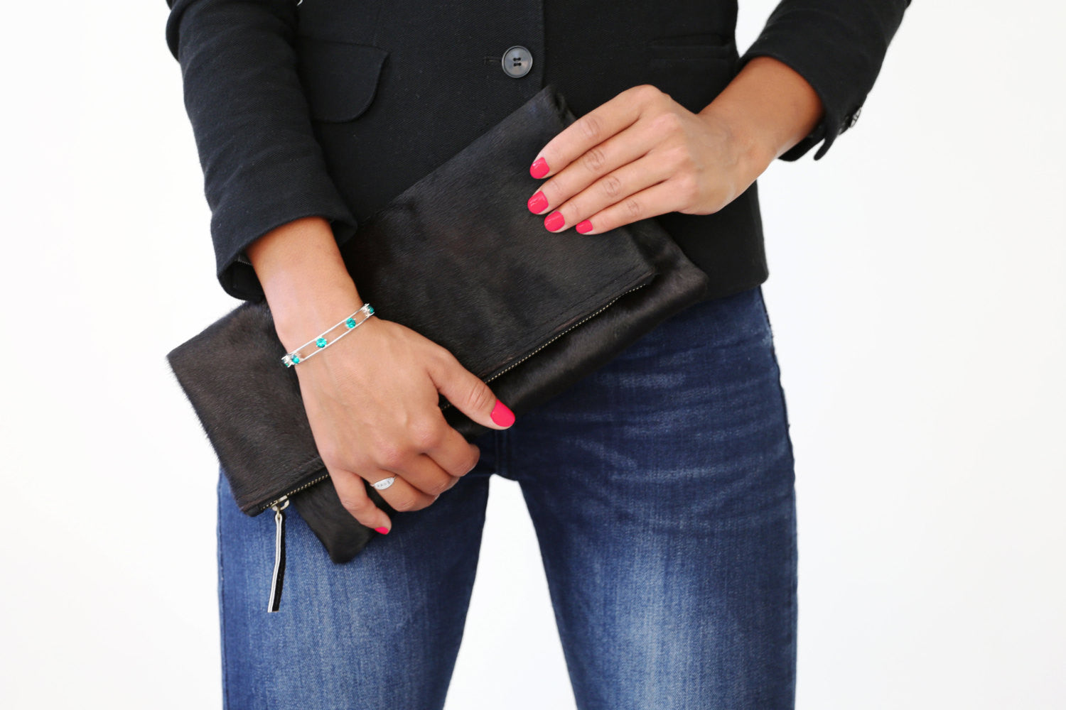 Model holding Calf Hair Leather Foldover Clutch 